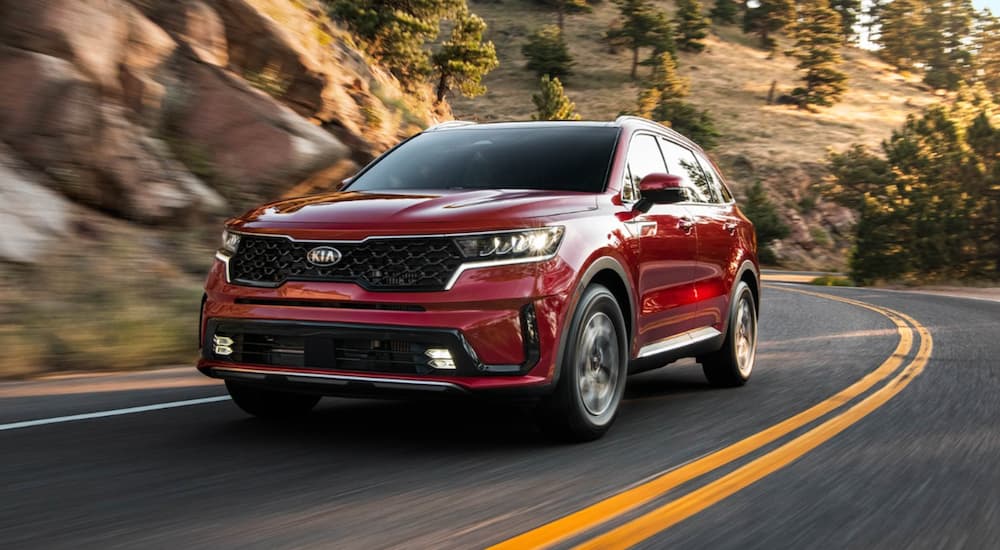 A red 2021 Kia Sorento is shown from the front at an angle.