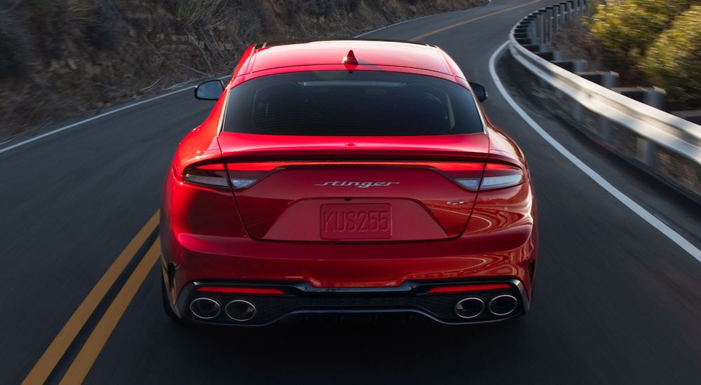 A red 2023 Kia Stinger GT is shown from the rear after leaving a used Kia dealer.