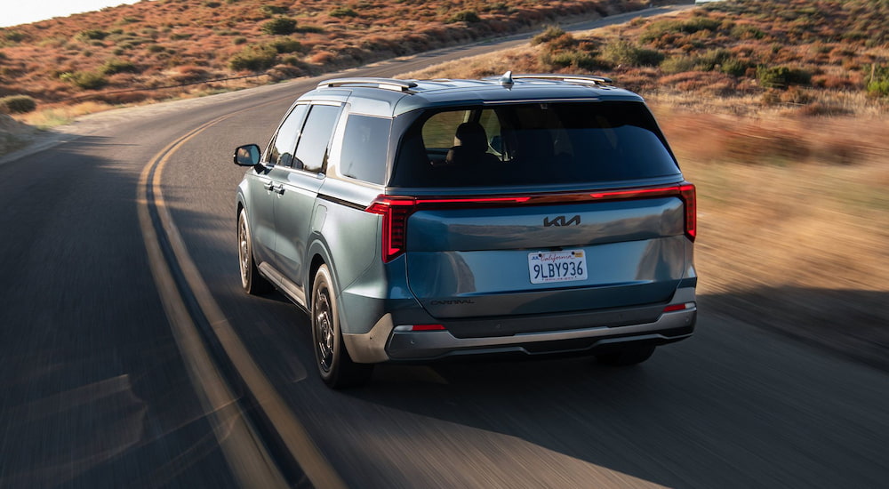 Rear of a blue 2026 Kia Carnival.