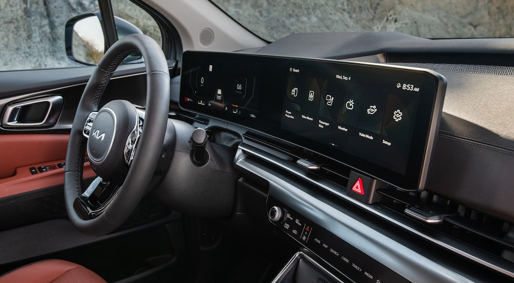 Dashboard screen and steering wheel inside of a 2026 Kia Carnival.