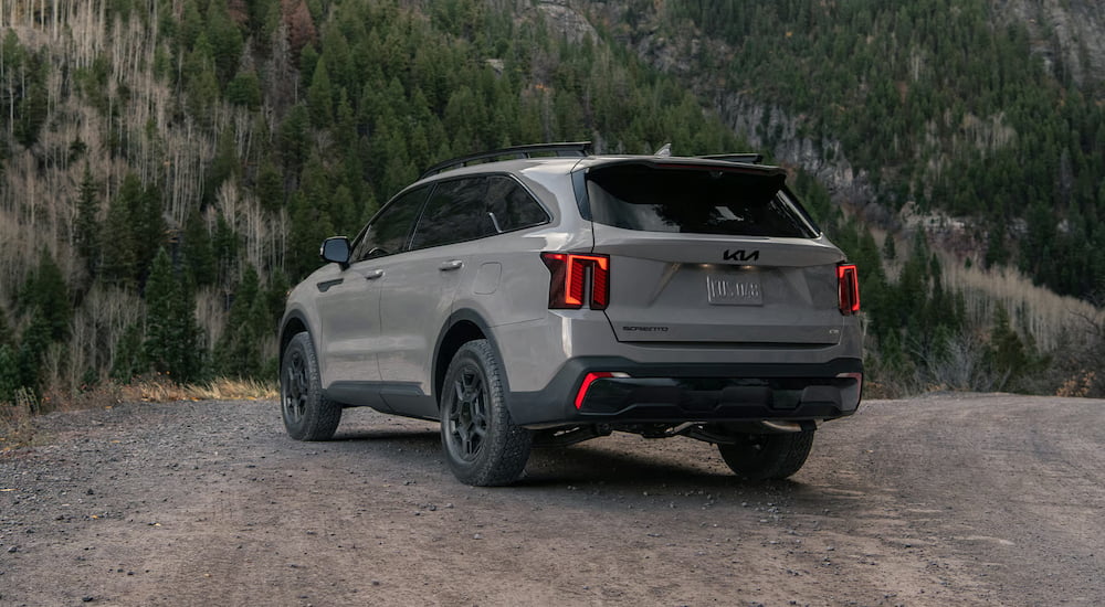 Rear of a grey 2026 Kia Sorento parked off-road.