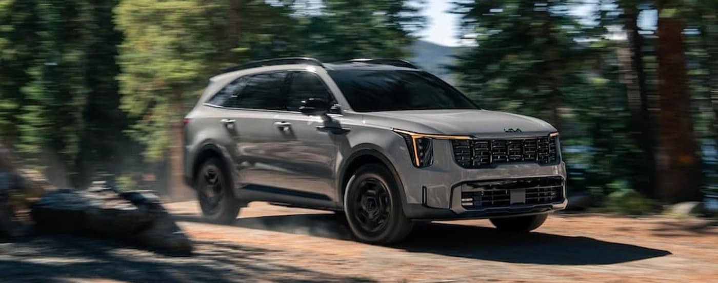 A gray 2025 Kia Sorento driving off-road.