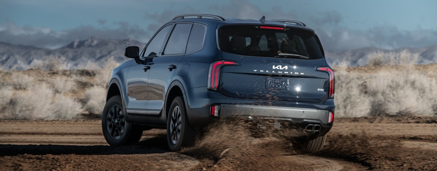 A blue 2023 Kia Telluride X-Pro off-roading